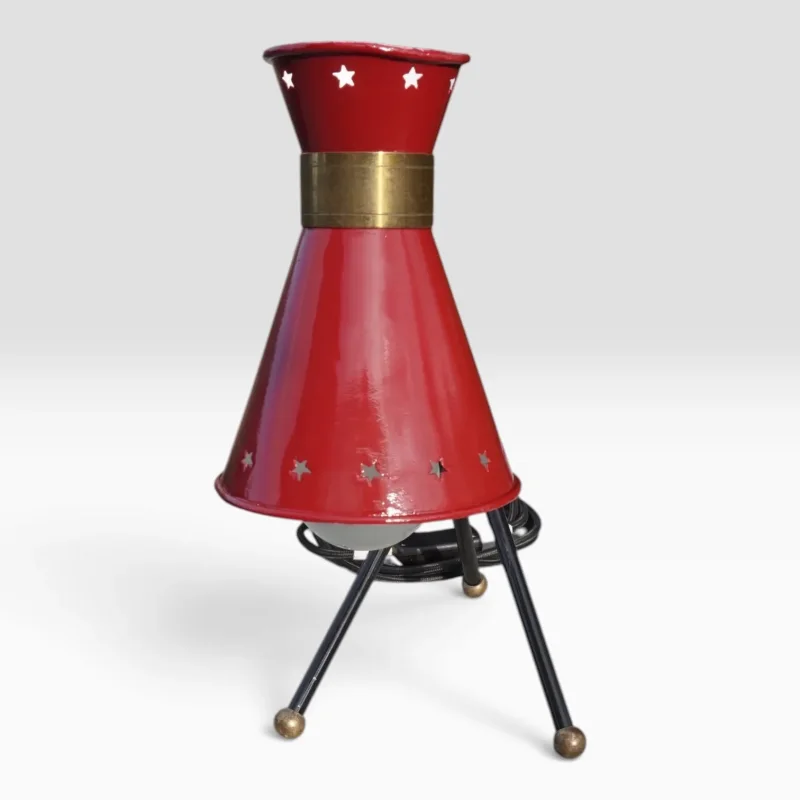 Close-up of the red star-perforated diabolo shade with brass collar, French mid-century table lamp attr. René Mathieu for Lunel