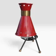 Close-up of the red star-perforated diabolo shade with brass collar, French mid-century table lamp attr. René Mathieu for Lunel
