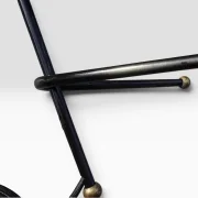 Detail of the black lacquered crossed tripod base with brass ball feet, French 1950s table lamp attr. René Mathieu for Lunel