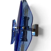 Side view of a VECA wall sconce with faceted blue glass and brass crossbar, showing two visible sockets