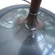 Arteluce Corolle floor lamp base showing extensive lacquer flaking and paint loss at stem connection point, restoration condition