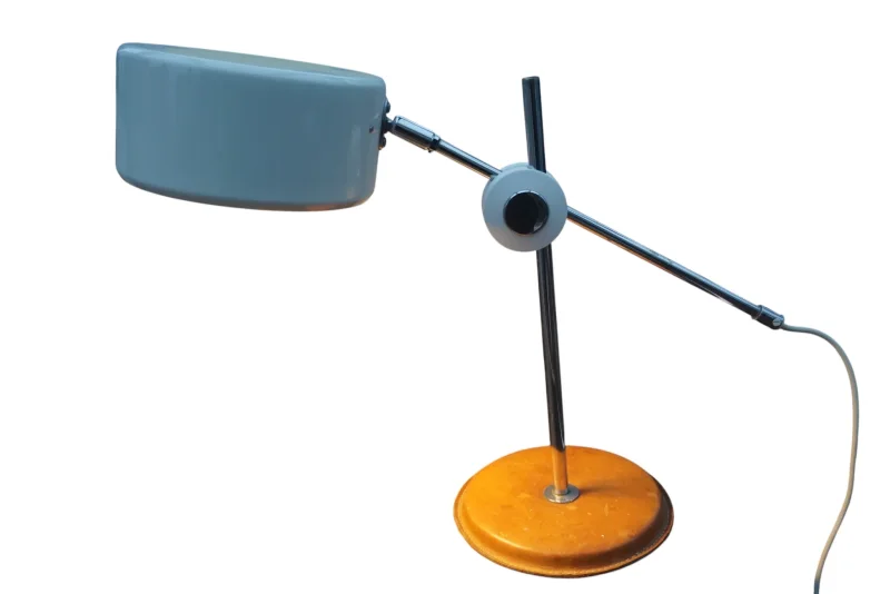 Side view of the Simris table lamp by Anders Pehrson with tilted shade, chrome arm and round leather base
