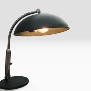 Close-up of the illuminated dome shade and chrome arm on the Hala Zeist model 144 desk lamp