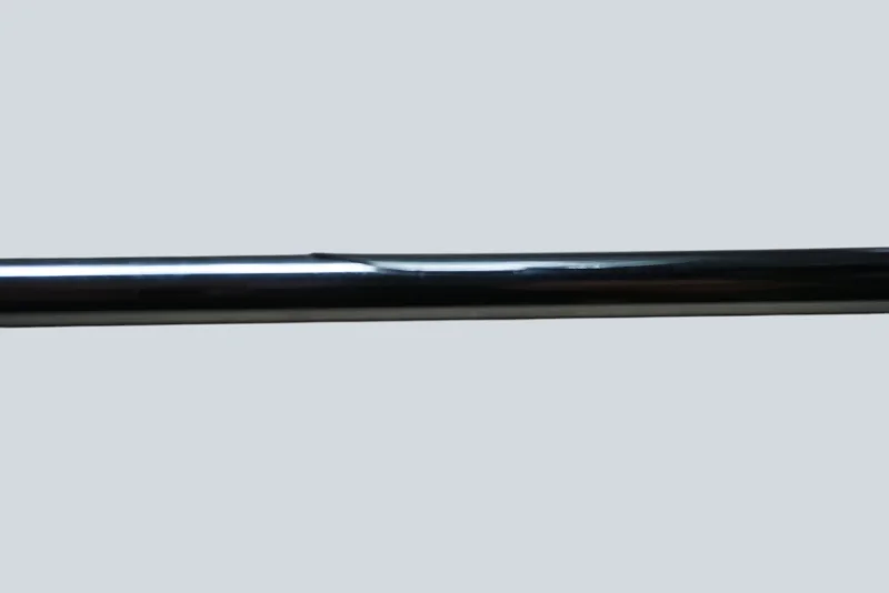 Close-up of the chrome-plated arm on a Cosack model 4166 wall sconce showing a small surface dent