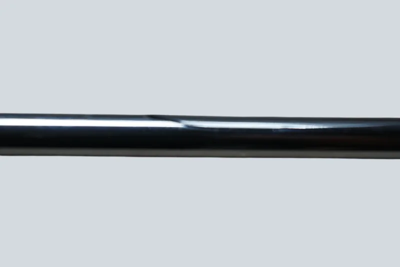 Detail view of the polished chrome rod on a Cosack 4166 wall light, showing surface texture and a minor dent