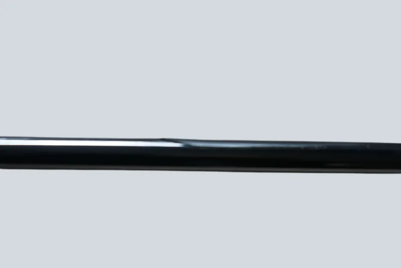 Close-up of the chrome tube on the Cosack 4166 wall sconce, highlighting the reflective finish and a small dent