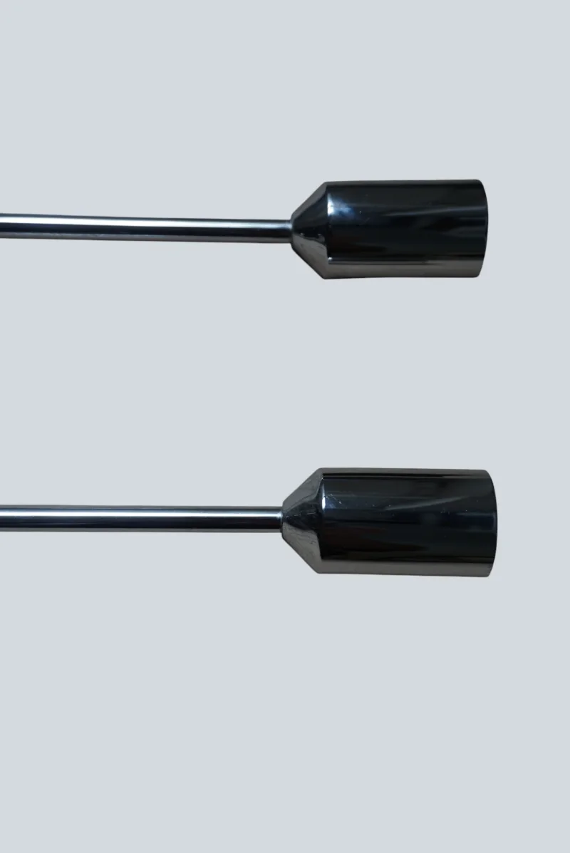 Close-up of two polished chrome finial caps on the Cosack model 4166 wall sconce pair