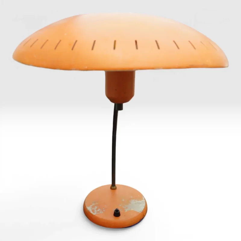 Front view of Philips Junior table lamp by Louis Kalff in orange with perforated dome shade and straight stem, 1950s