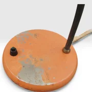 Close-up of Philips Junior orange base with paint loss exposing bare metal, on/off switch and textile cord