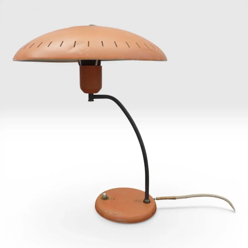 Philips Junior table lamp by Louis Kalff in faded orange with curved black arm and round base, Netherlands 1950s