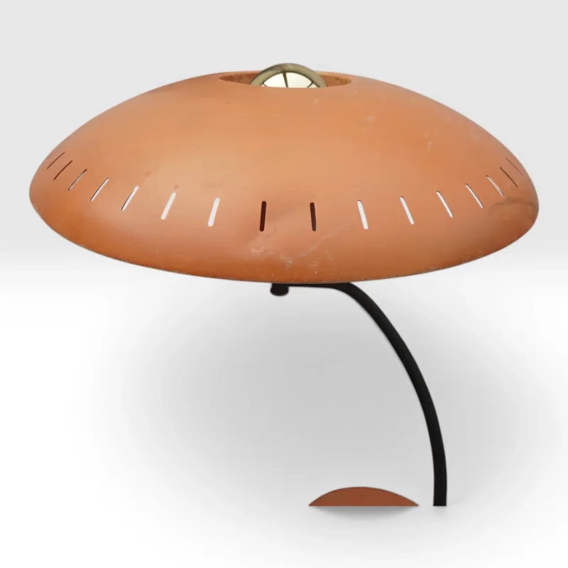 Side view of Philips Junior table lamp showing curved black arm, perforated dome shade and orange base, 1950s