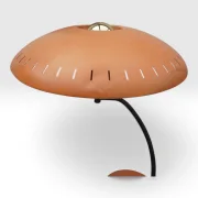 Side view of Philips Junior table lamp showing curved black arm, perforated dome shade and orange base, 1950s