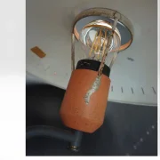 Close-up of Philips Junior socket housing showing paint loss and age wear on orange lacquer, 1950s