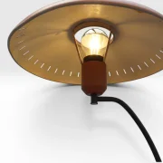 View from below into illuminated Philips Junior shade showing gold interior and filament bulb, Louis Kalff 1950s